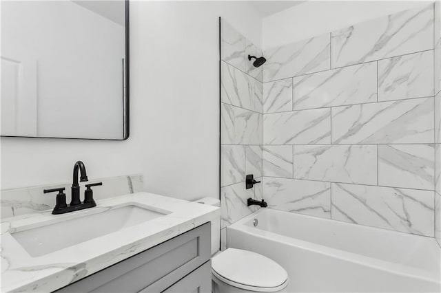 full bathroom with toilet, vanity, and tiled shower / bath