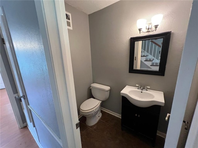 bathroom with tile patterned floors, vanity, and toilet