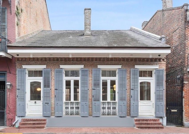 810 Bourbon St, New Orleans, LA 70116 - property entrance with covered porch and brick siding