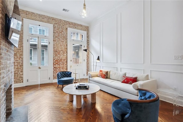 810 Bourbon St, New Orleans, LA 70116 - living room featuring a decorative wall, brick wall, and ornamental molding