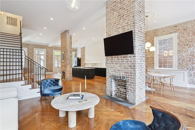 810 Bourbon St, New Orleans, LA 70116 - living room with stairs, a fireplace, and brick wall