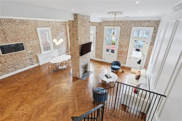 810 Bourbon St, New Orleans, LA 70116 - living area featuring a fireplace, brick wall, baseboards, and recessed lighting