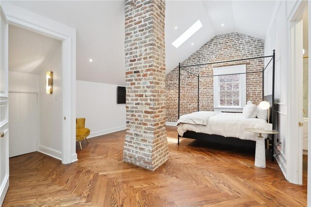 810 Bourbon St, New Orleans, LA 70116 - bedroom featuring lofted ceiling, a skylight, baseboards, and brick wall