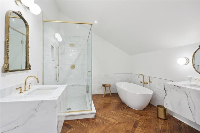 810 Bourbon St, New Orleans, LA 70116 - full bath with lofted ceiling, a shower stall, vanity, a freestanding tub, and wainscoting