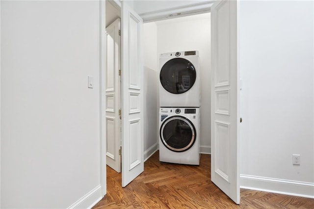 810 Bourbon St, New Orleans, LA 70116 - laundry area featuring stacked washer and clothes dryer and baseboards