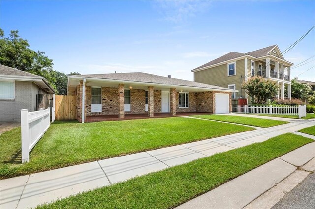 view of front of property with a front lawn and a garage