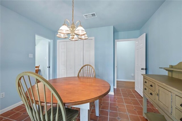 dining space featuring an inviting chandelier