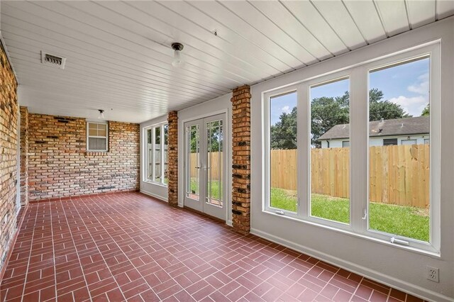 unfurnished sunroom with french doors