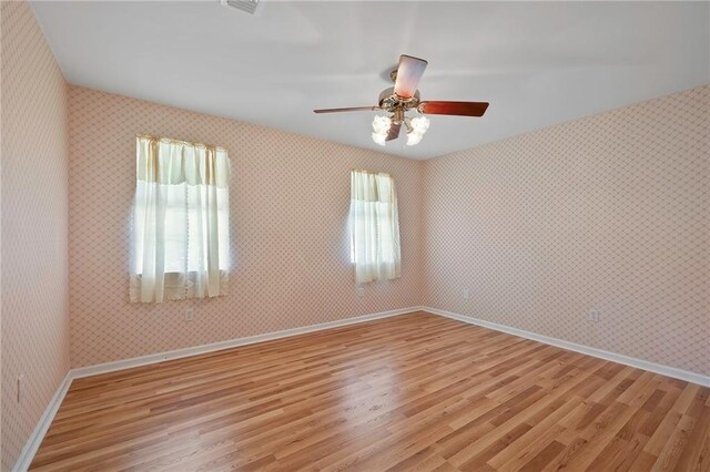 empty room featuring ceiling fan and light wood-type flooring