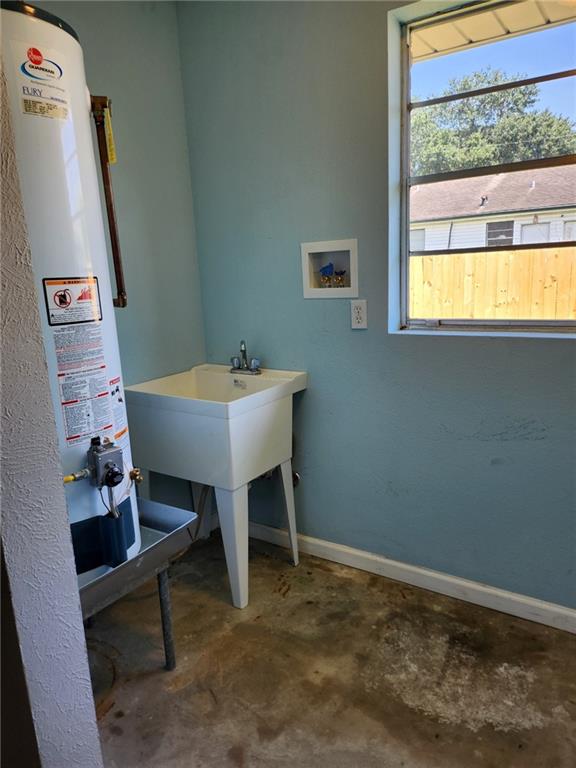 bathroom with concrete flooring and gas water heater