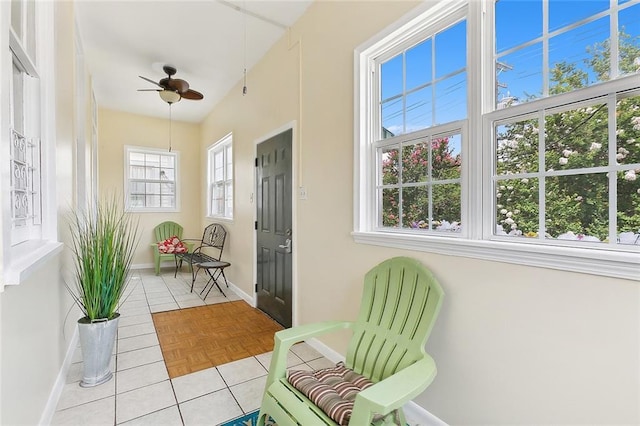 sunroom / solarium featuring ceiling fan