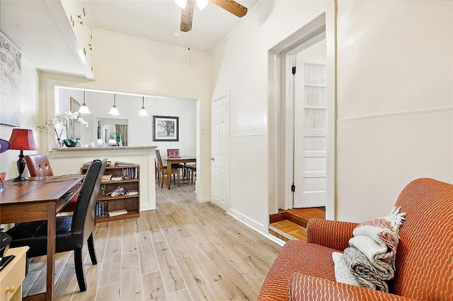 office space featuring crown molding, ceiling fan, and light wood-type flooring