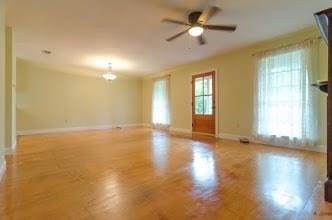 unfurnished living room with ceiling fan