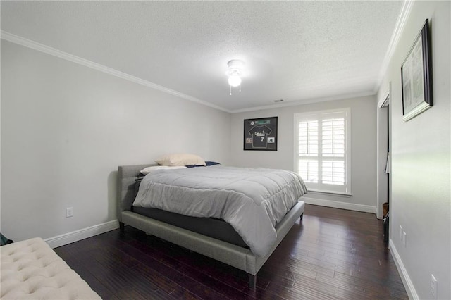 bedroom featuring a textured ceiling, dark hardwood / wood-style floors, and ornamental molding