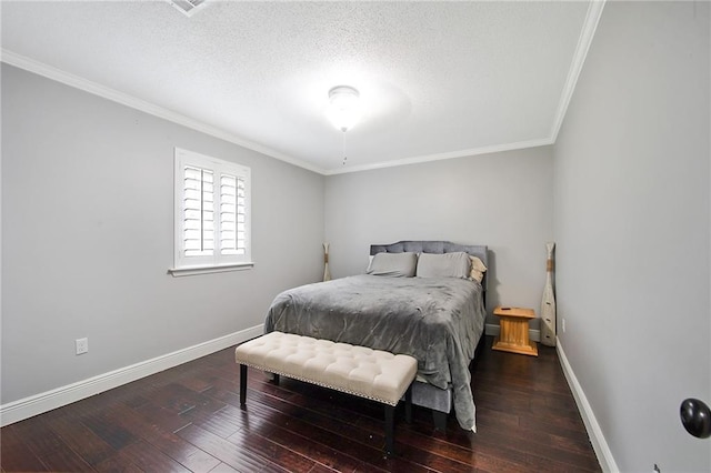 bedroom with dark hardwood / wood-style flooring, ornamental molding, and a textured ceiling