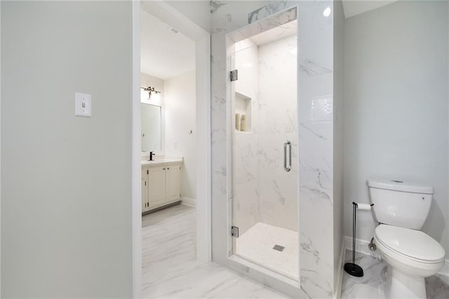 bathroom featuring a shower with door, vanity, and toilet