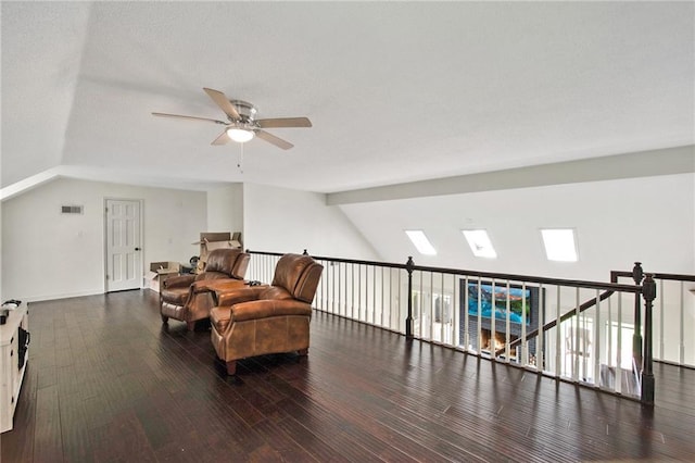 sitting room featuring ceiling fan, dark hardwood / wood-style floors, and lofted ceiling