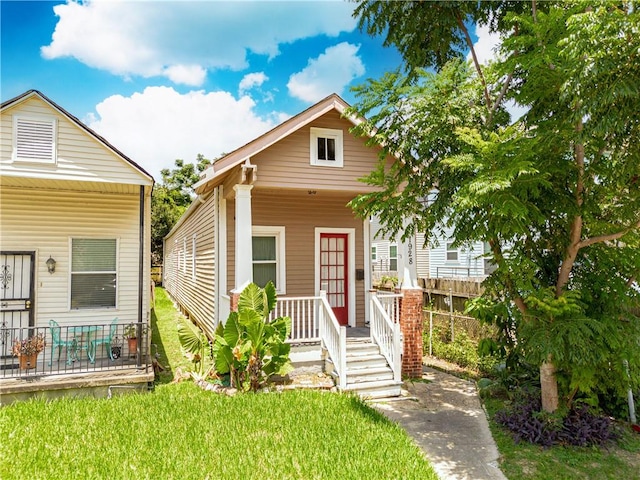 bungalow-style house with a front yard