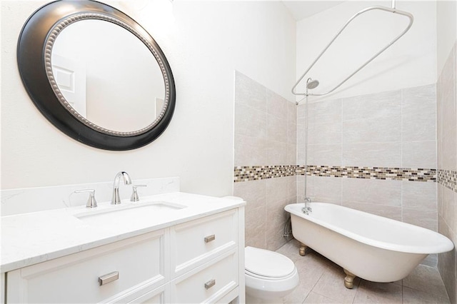 bathroom with vanity, a tub to relax in, tile patterned flooring, and toilet