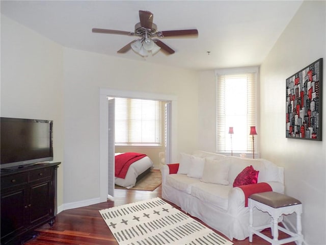 living room with dark hardwood / wood-style floors and ceiling fan