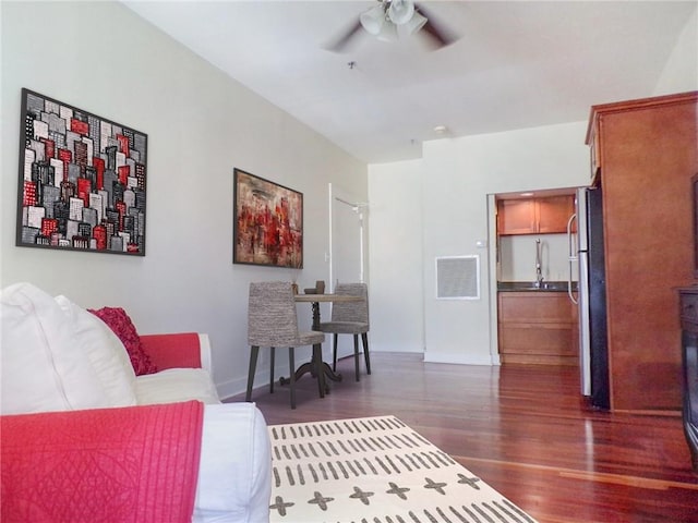 living room with ceiling fan and dark hardwood / wood-style floors