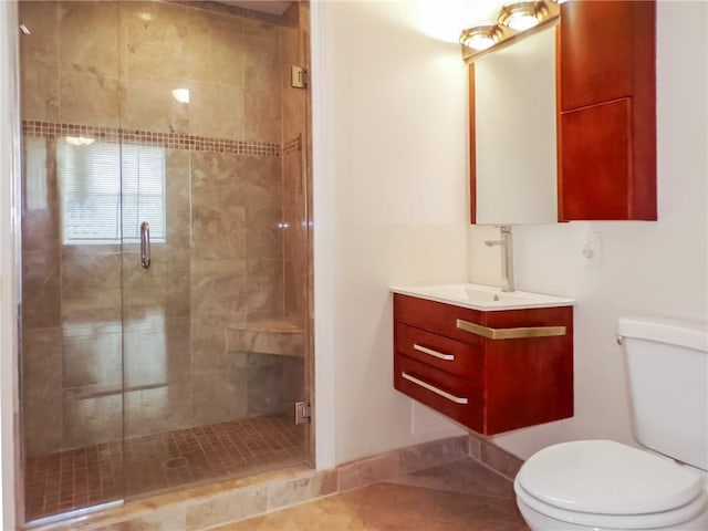 bathroom featuring tile patterned flooring, a shower with door, toilet, and vanity