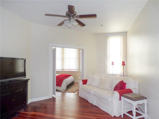 living room with dark hardwood / wood-style floors, a healthy amount of sunlight, and ceiling fan