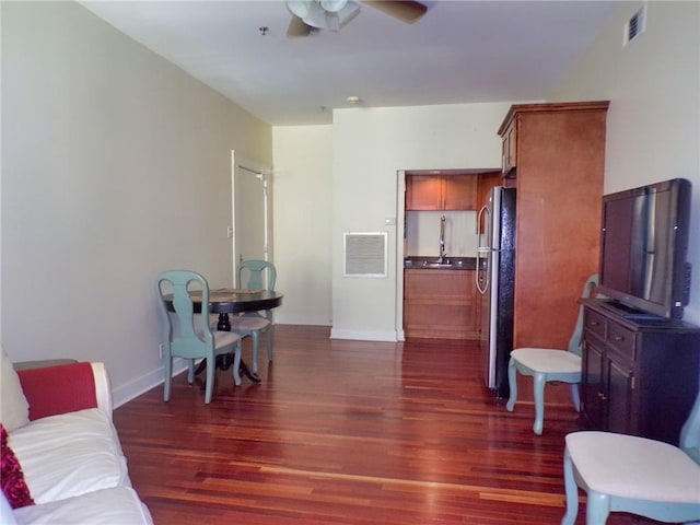 interior space with ceiling fan and dark wood-type flooring