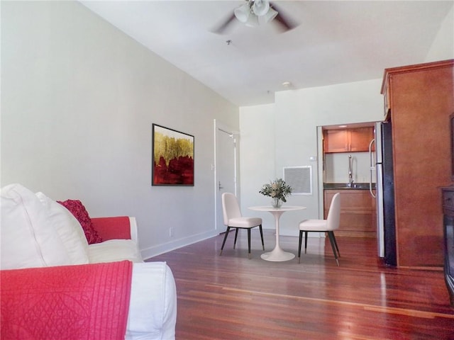 sitting room with dark hardwood / wood-style flooring and ceiling fan