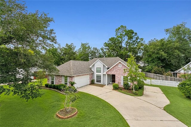 view of front of house with a garage and a front yard