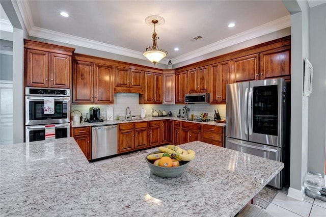 kitchen with sink, light stone countertops, crown molding, decorative light fixtures, and appliances with stainless steel finishes