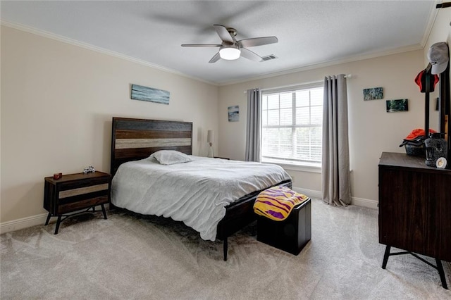 carpeted bedroom with ornamental molding and ceiling fan