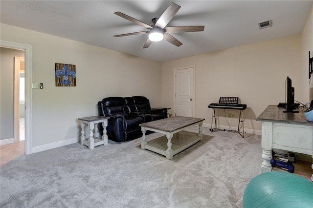 carpeted living room with ceiling fan