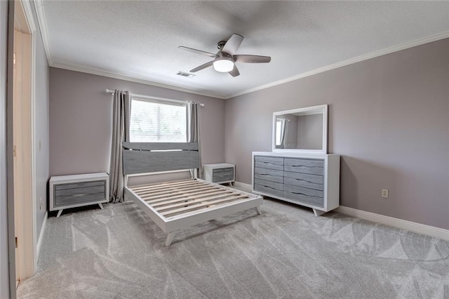 carpeted bedroom featuring ceiling fan, ornamental molding, and a textured ceiling