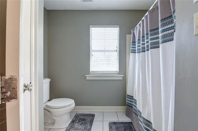 bathroom with toilet and tile patterned flooring