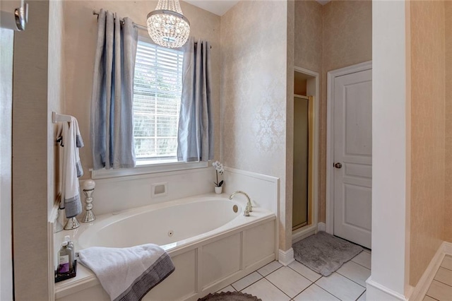 bathroom featuring tile patterned floors, shower with separate bathtub, and an inviting chandelier