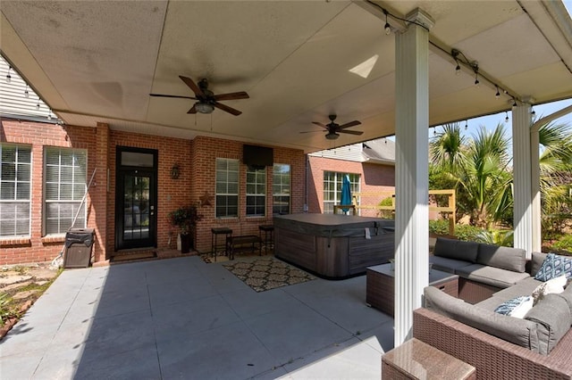 view of patio featuring a hot tub, an outdoor living space, and ceiling fan