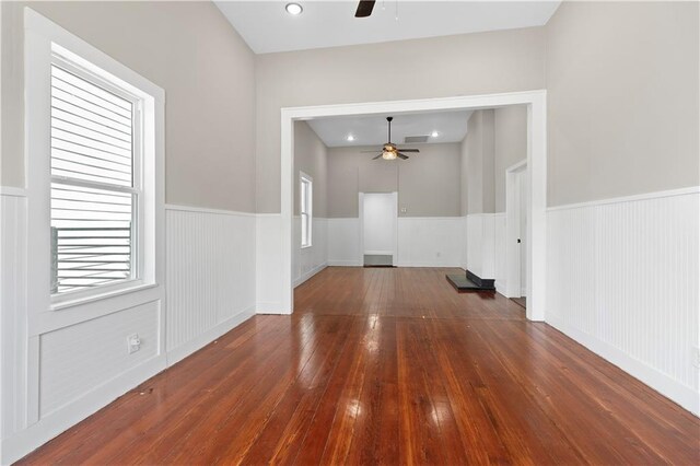 unfurnished room featuring plenty of natural light, ceiling fan, and hardwood / wood-style floors