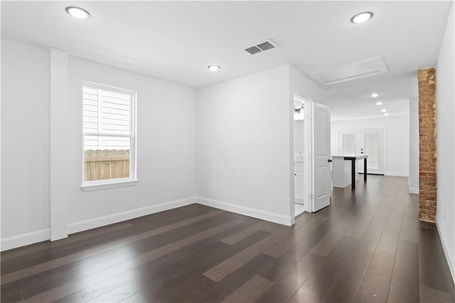 spare room with dark hardwood / wood-style flooring