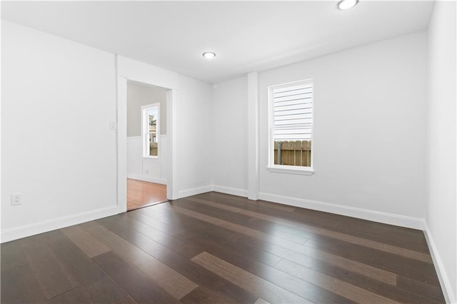 spare room with dark hardwood / wood-style flooring