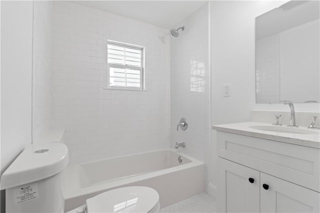 full bathroom with tiled shower / bath, vanity, and toilet