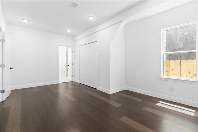 unfurnished room featuring dark hardwood / wood-style flooring