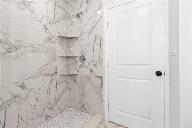 bathroom with tiled shower