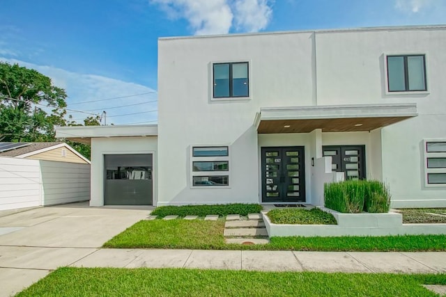 4317 Anthony St, Metairie, LA 70001 - modern home with stucco siding, french doors, concrete driveway, and a garage