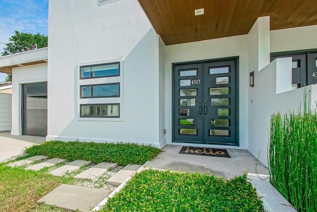 4317 Anthony St, Metairie, LA 70001 - property entrance with stucco siding, french doors, and driveway