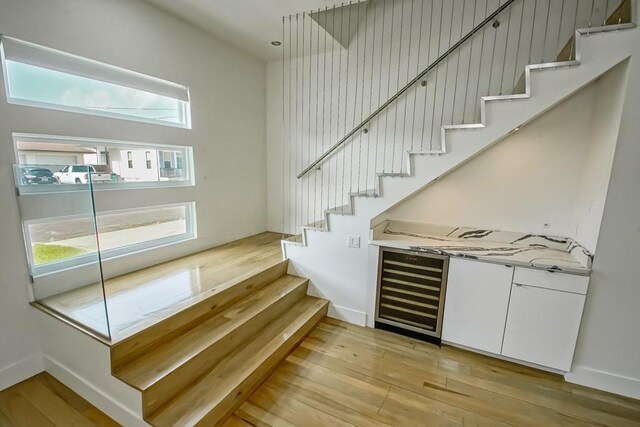4317 Anthony St, Metairie, LA 70001 - stairway with wood finished floors, bar area, and baseboards