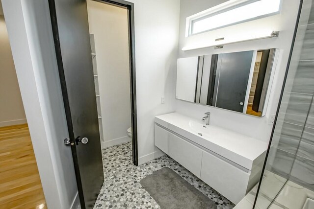 4317 Anthony St, Metairie, LA 70001 - bathroom with toilet, baseboards, and vanity