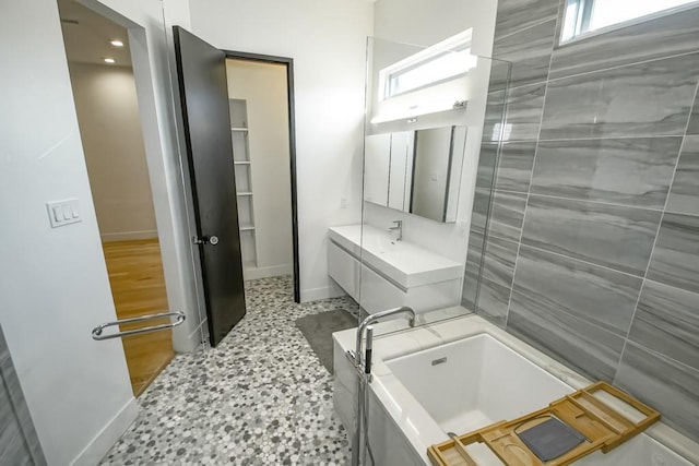 4317 Anthony St, Metairie, LA 70001 - full bath with baseboards, a tub to relax in, vanity, and recessed lighting