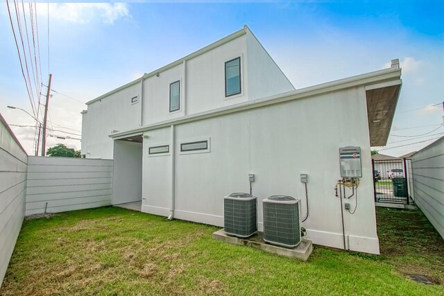 4317 Anthony St, Metairie, LA 70001 - rear view of property featuring central AC unit and stucco siding
