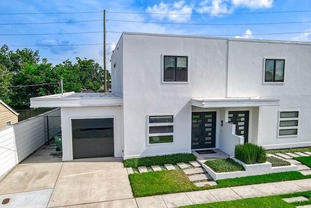 4317 Anthony St, Metairie, LA 70001 - view of front of home with stucco siding, fence, concrete driveway, and french doors